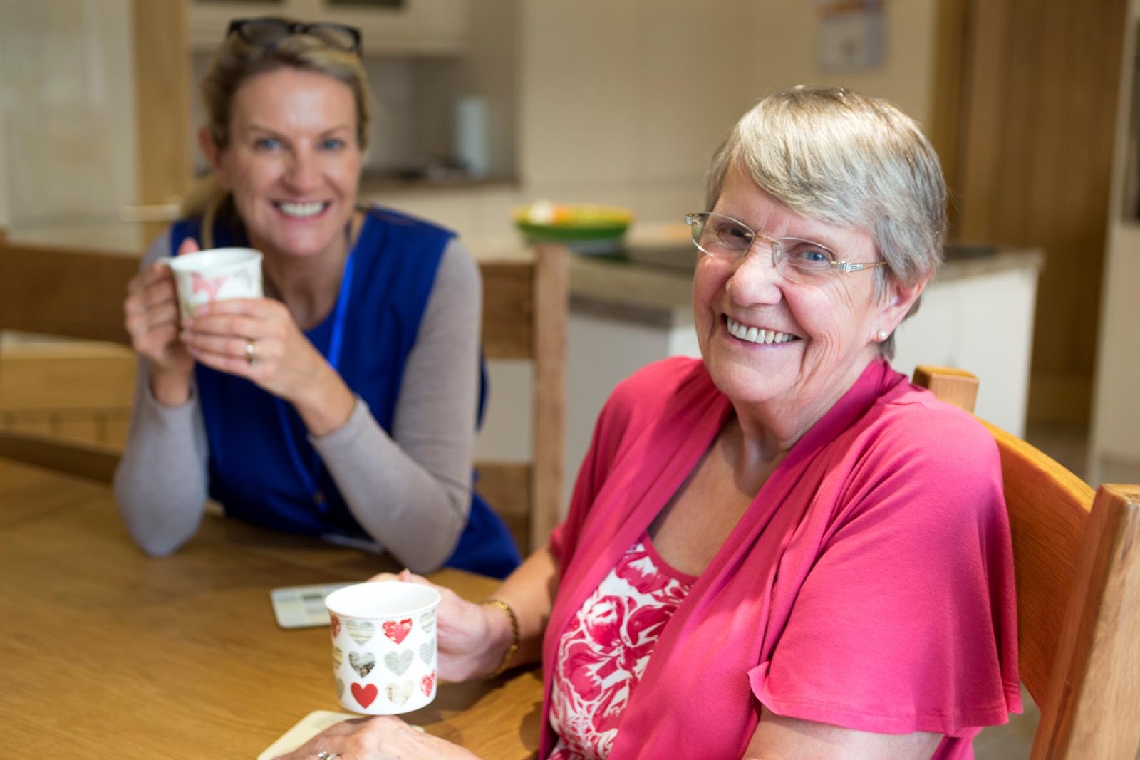 A live-in carer spending time with an older woman at home
